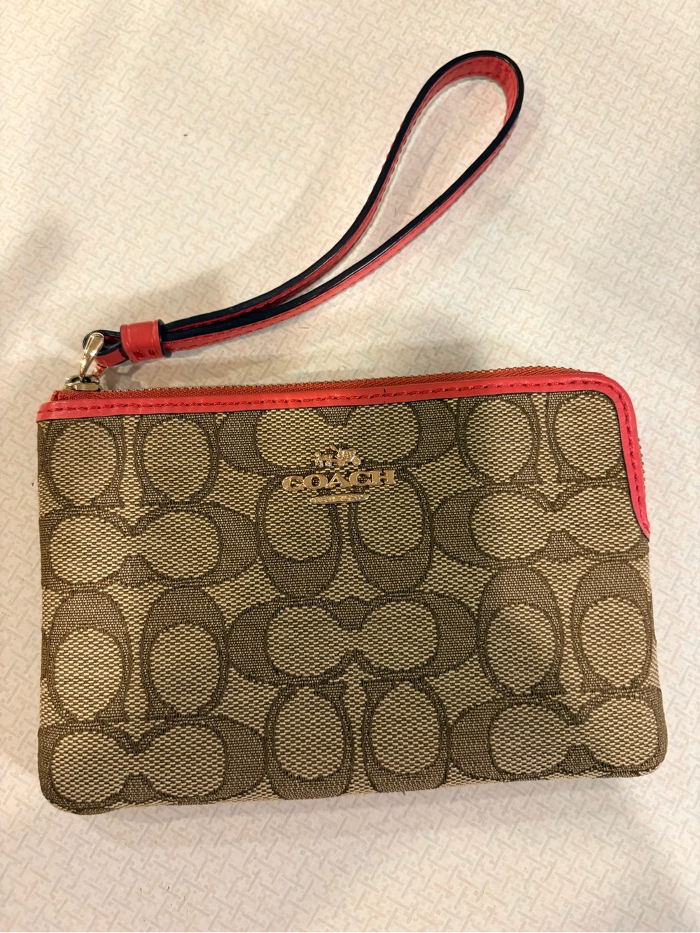COACH Brown Signature Canvas Wristlet with Coral Trim
